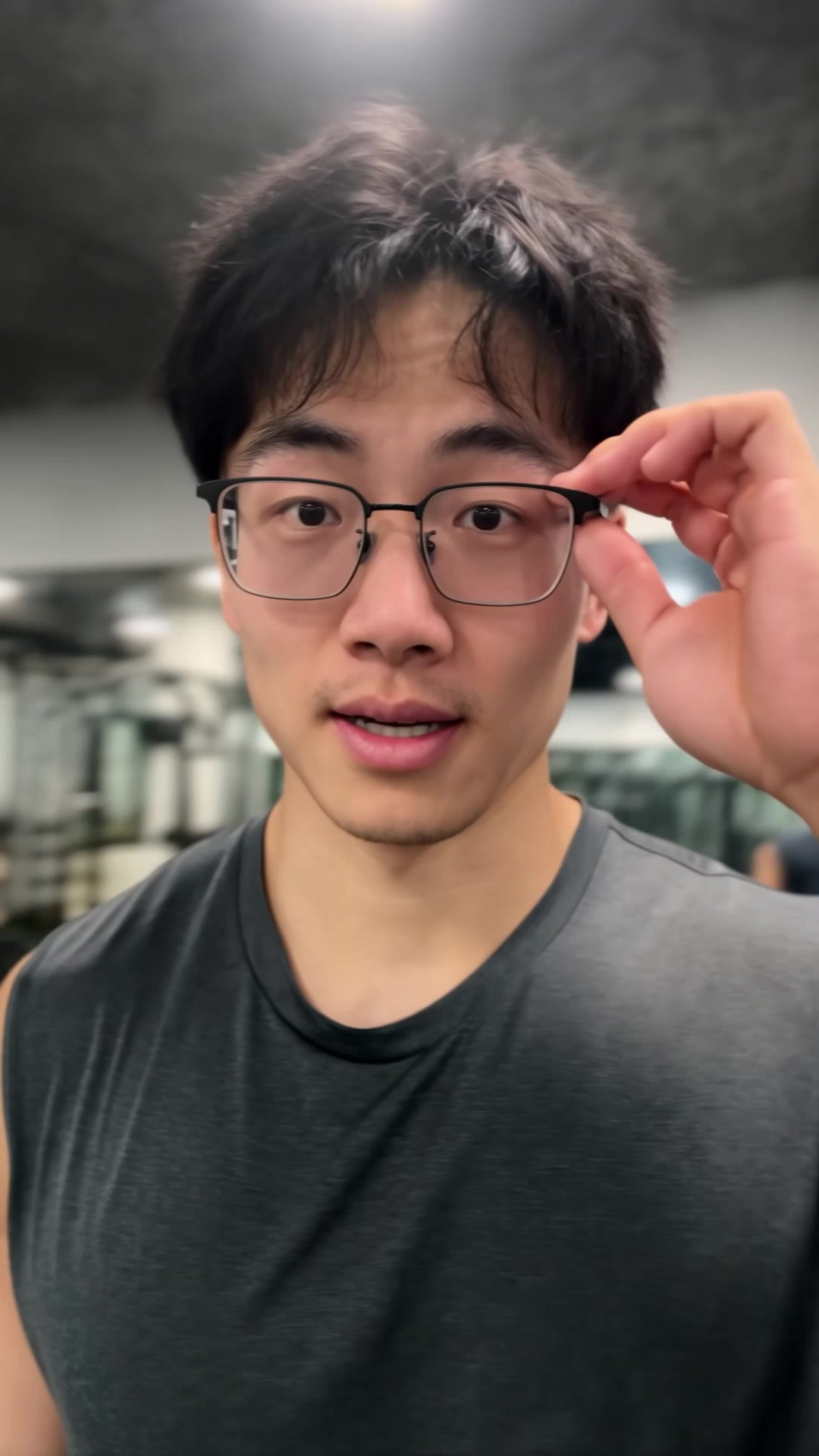 Man adjusting his glasses at the start of a longer scene